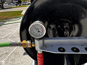 Close-up of hydro jetting pressure gauge during sewer line cleaning in Rialto CA