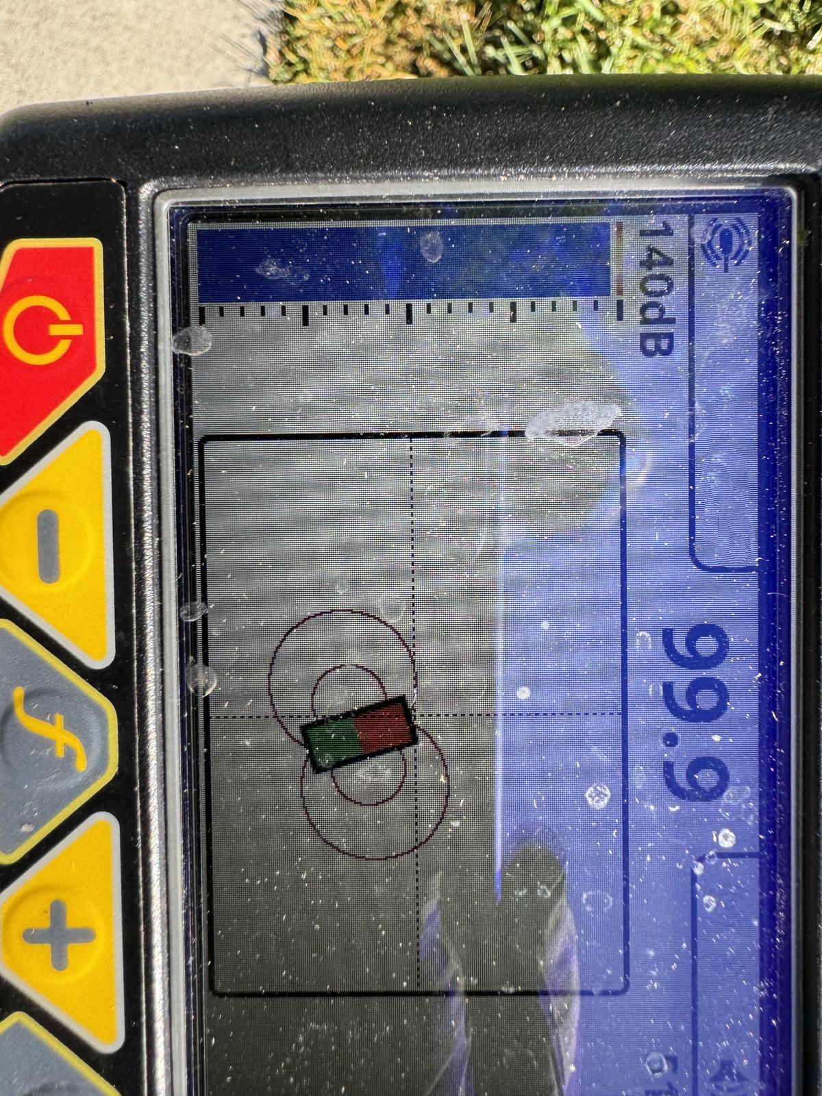 Handheld sewer line locator receiver display showing signal strength during a main line trace