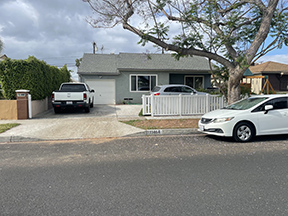 Older residential home in San Bernardino CA with mature tree in front yard — typical of neighborhoods where sewer scope inspections reveal aging pipe conditions