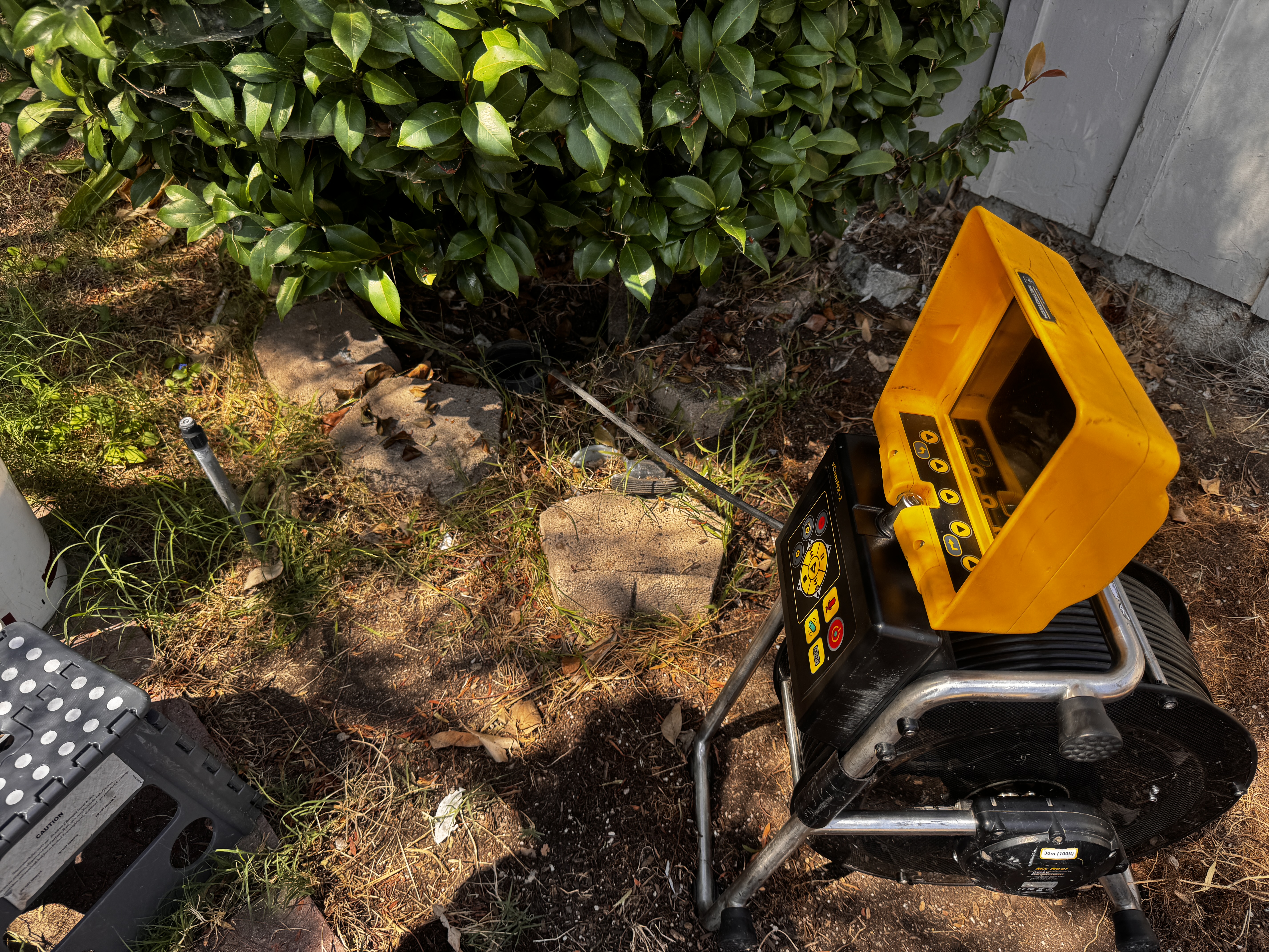 FlowProIE technician setting up sewer scope camera equipment at a cleanout access point in Fontana