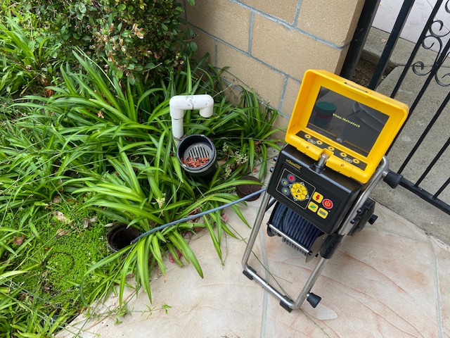 FlowPro sewer camera reel and monitor deployed at a residential access point